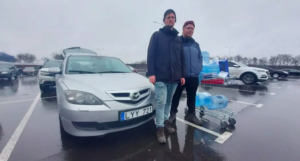 Stefan Weichert (left) and Emil Filtenborg in front of their car, which they had to flee in when they were shot. Credit: Emil Filtenborg.