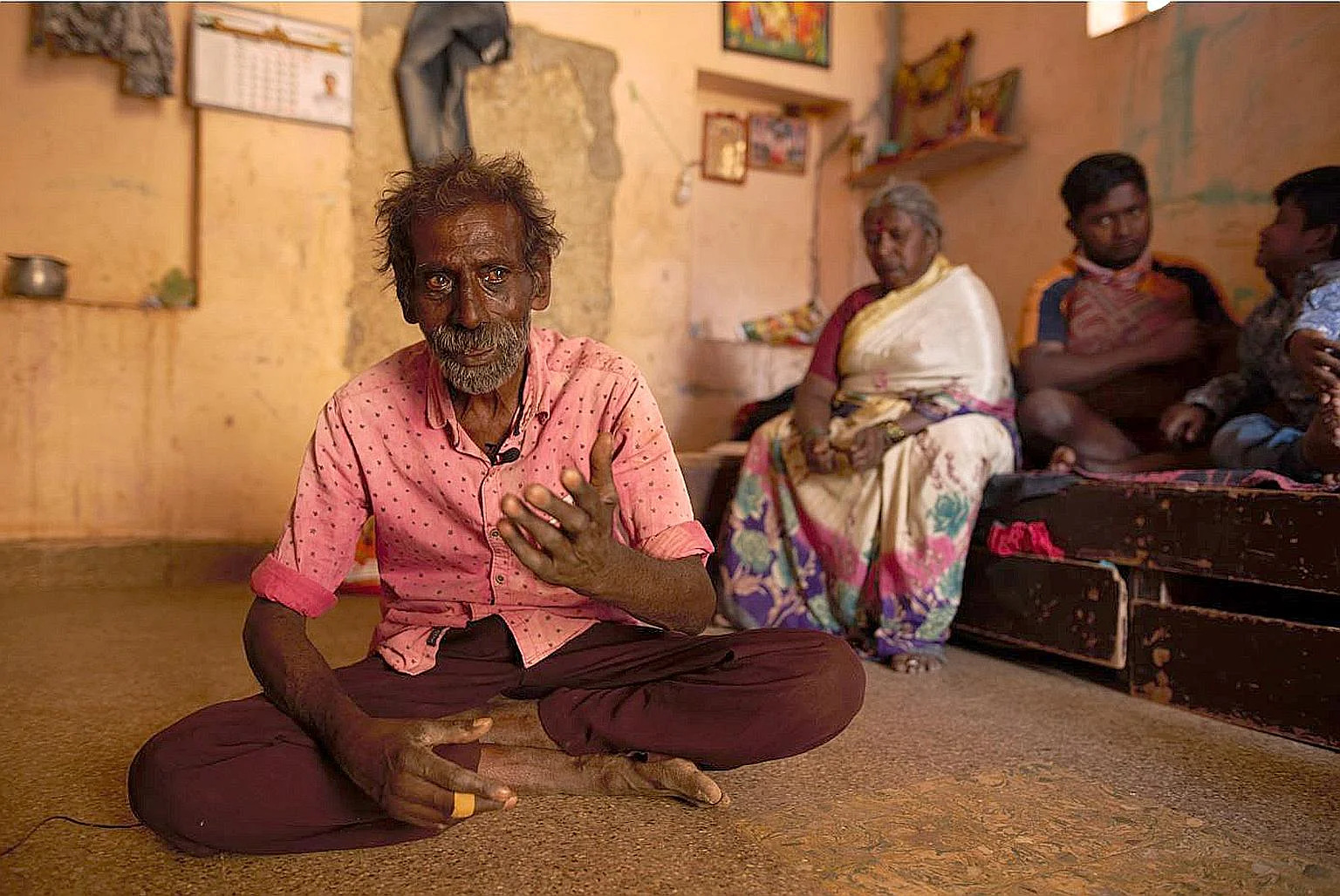 Mr Munisamy Katappa at home with his family. He says he drinks so he can "endure the horrid stink of excrement, and the disgust and humiliation" that he feels. Photo: Arvind Dev.