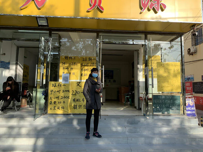 A recruiter keeps an eye out for potential workers outside a labour agency at the Majuqiao market. Photo: Danson Cheong.